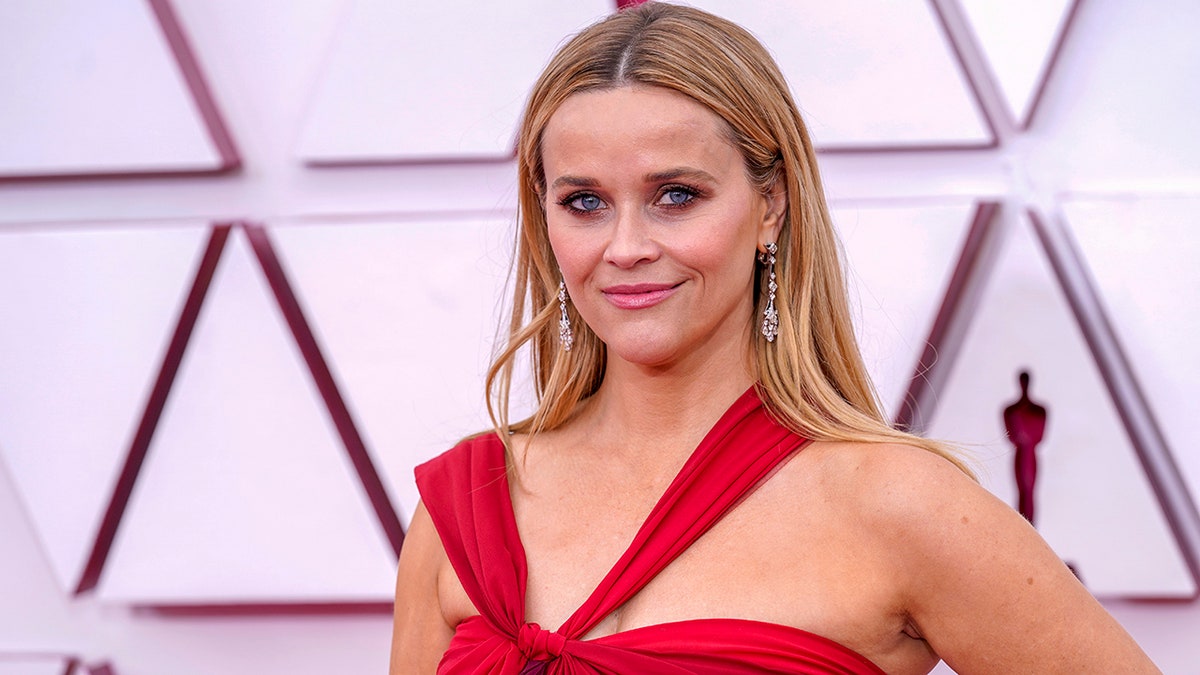 Reese Witherspoon in a red halter dress on the Oscars carpet